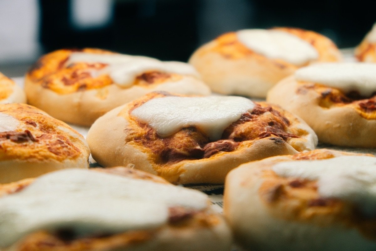 Tray of Calabrian nduja pizzette topped with melted mozzarella