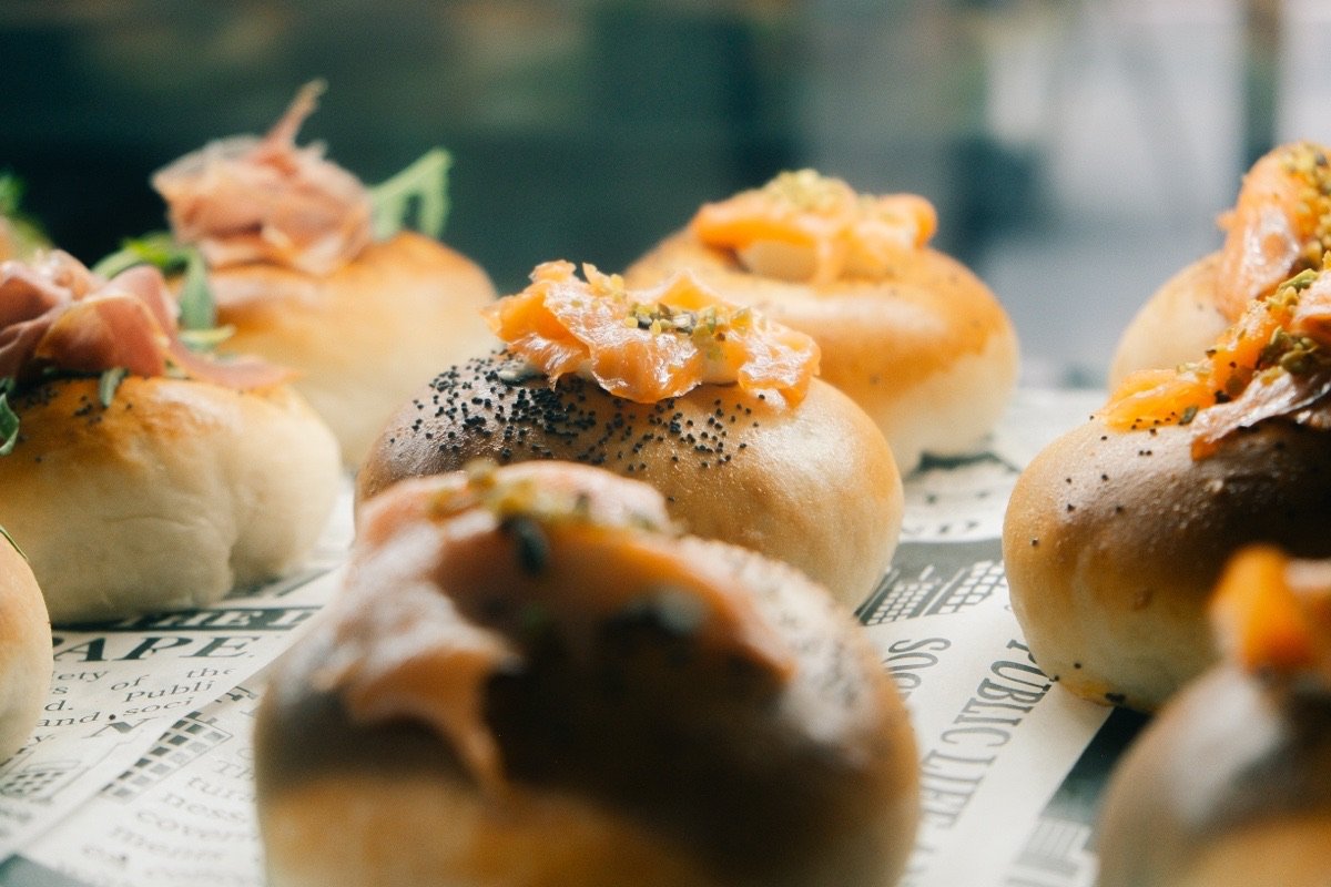 Counter display of filled buns with smoked salmon and Parma ham